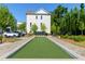 Enjoy outdoor games on the manicured bocce ball court, framed by sidewalks, landscaping and neighboring buildings at 451 Burton Dr # 32, Alpharetta, GA 30009