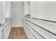 Walk-in closet with custom shelving and drawers, wood flooring, and ample space for wardrobe and storage needs at 451 Burton Dr # 32, Alpharetta, GA 30009