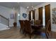 Elegant dining room featuring wood flooring, a chandelier, and rich brown curtains, ideal for hosting memorable gatherings at 451 Burton Dr # 32, Alpharetta, GA 30009