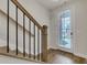 Inviting entryway featuring wood flooring, a staircase with metal spindles, and a glass front door letting in natural light at 451 Burton Dr # 32, Alpharetta, GA 30009