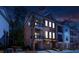 Brick townhome with balconies and a garage, illuminated by exterior and interior lights at 451 Burton Dr # 32, Alpharetta, GA 30009