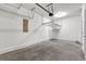 Spacious two car garage interior featuring ample storage with overhead racks and bright lighting, perfect for vehicles and projects at 451 Burton Dr # 32, Alpharetta, GA 30009