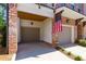 Attached two-car garages with an American flag adorning the facade at 451 Burton Dr # 32, Alpharetta, GA 30009