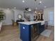 Open concept kitchen features an island with bar seating, wine fridge, and stainless-steel appliances, perfect for entertaining at 451 Burton Dr # 32, Alpharetta, GA 30009