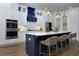 Modern kitchen with island, marble countertop, stainless steel appliances and overhead lighting at 451 Burton Dr # 32, Alpharetta, GA 30009