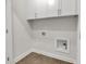 Functional laundry room with tile flooring, storage cabinets, and washer/dryer hookups at 451 Burton Dr # 32, Alpharetta, GA 30009