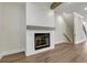 Living room area showing a fireplace, hardwood floors, and staircase; light paint and white trim at 451 Burton Dr # 32, Alpharetta, GA 30009