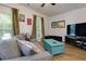 Comfortable living room features a ceiling fan, large windows, and a cozy gray sofa at 451 Burton Dr # 32, Alpharetta, GA 30009