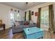 Comfortable living room with backyard access, a ceiling fan, and cozy gray sofa at 451 Burton Dr # 32, Alpharetta, GA 30009