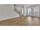 Bright living room featuring wood floors, modern lighting, and staircase with wood and iron railings at 451 Burton Dr # 32, Alpharetta, GA 30009