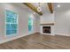 Living room with hardwood floors, fire place and beams; light paint and bright windows at 451 Burton Dr # 32, Alpharetta, GA 30009