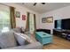 Comfortable living room with a gray sofa, blue coffee table, large windows with curtains, and wood flooring at 451 Burton Dr # 32, Alpharetta, GA 30009