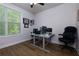 Bright office space featuring wood floors, a large window and dual workstation setup at 451 Burton Dr # 32, Alpharetta, GA 30009