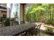 Outdoor patio with an ornate metal table set with chairs, overlooking a landscaped backyard at 451 Burton Dr # 32, Alpharetta, GA 30009