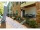 Covered patio with outdoor seating surrounded by lush landscaping and shade trees at 451 Burton Dr # 32, Alpharetta, GA 30009