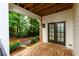Charming brick patio with double doors leads to a serene, private fenced backyard perfect for relaxing and entertaining outdoors at 451 Burton Dr # 32, Alpharetta, GA 30009