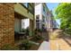 Backyard patio with table and chairs, bordering manicured yard of townhome community at 451 Burton Dr # 32, Alpharetta, GA 30009