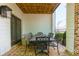Patio with brick floor, decorative table and chairs, with access to home and yard at 451 Burton Dr # 32, Alpharetta, GA 30009