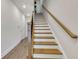 Classic staircase with wood stairs and rails, leading to the upper level of the home at 451 Burton Dr # 32, Alpharetta, GA 30009
