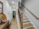 Inviting foyer with wood-look flooring and staircase with light wood treads and handrail at 451 Burton Dr # 32, Alpharetta, GA 30009