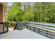 Back deck offering a view of the private, wooded yard and seating area perfect for outdoor relaxation and entertaining at 4849 Chapelle Ct, Marietta, GA 30066