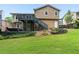 Backyard featuring a deck, hot tub, and a well-manicured lawn with landscaping at 4849 Chapelle Ct, Marietta, GA 30066