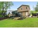 Expansive backyard with a deck, patio, lush landscaping, and green grass at 4849 Chapelle Ct, Marietta, GA 30066