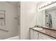 Bathroom with a combined shower and tub, granite vanity, and new lighting at 4849 Chapelle Ct, Marietta, GA 30066