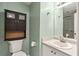 Bathroom with modern fixtures including sink, toilet, vanity mirror and shower at 4849 Chapelle Ct, Marietta, GA 30066