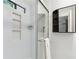 Bathroom with a tiled shower with built-in shelving, mirror, and dark storage cabinet at 4849 Chapelle Ct, Marietta, GA 30066
