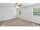 This bright bedroom features two windows providing natural light and soft carpet at 4849 Chapelle Ct, Marietta, GA 30066