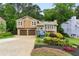 Charming home with a two-car garage, complemented by lovely landscaping and a beautiful garden in the front yard at 4849 Chapelle Ct, Marietta, GA 30066