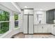 Bright kitchen featuring white cabinetry, stainless steel appliances, hardwood floors, and a large window with backyard views at 4849 Chapelle Ct, Marietta, GA 30066