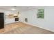 Open-plan living area with kitchen, featuring bright cabinets and hardwood floors at 4849 Chapelle Ct, Marietta, GA 30066