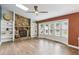Spacious living room featuring a stone fireplace, built-in shelving, large windows, and hardwood floors for a cozy atmosphere at 4849 Chapelle Ct, Marietta, GA 30066
