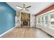 Bright living room with a stone fireplace, built-in shelves, hardwood floors, and expansive windows that let in natural light at 4849 Chapelle Ct, Marietta, GA 30066
