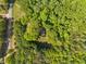 An aerial view of a wooded property with trees and an adjacent access road at 659 Pleasant Hill Nw Rd, Conyers, GA 30012