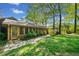 Lush backyard features a stone pathway leading to a charming home exterior at 659 Pleasant Hill Nw Rd, Conyers, GA 30012