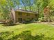 Spacious backyard features lush lawn, mature trees, a brick patio, and beautiful landscaping perfect for outdoor living at 659 Pleasant Hill Nw Rd, Conyers, GA 30012
