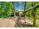 This backyard features mature trees, picnic area, brick landscaping, and outdoor swing at 659 Pleasant Hill Nw Rd, Conyers, GA 30012