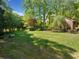 A sprawling backyard featuring manicured lawn and wooded perimeter offering ample outdoor space at 659 Pleasant Hill Nw Rd, Conyers, GA 30012