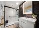 Modern bathroom featuring a sleek vanity, stylish mirror, and a glass-enclosed shower at 659 Pleasant Hill Nw Rd, Conyers, GA 30012