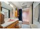This bathroom offers a unique and retro design, including pink tiling and cabinet at 659 Pleasant Hill Nw Rd, Conyers, GA 30012