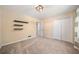 This cozy bedroom features neutral paint, carpeted floors, a modern light fixture and closet space at 659 Pleasant Hill Nw Rd, Conyers, GA 30012