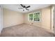Bright bedroom featuring large windows and neutral carpeting at 659 Pleasant Hill Nw Rd, Conyers, GA 30012