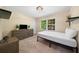 Cozy bedroom featuring a large window and a modern dresser at 659 Pleasant Hill Nw Rd, Conyers, GA 30012