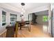 Bright dining area with hardwood floors, ample natural light, and views of the living room's brick fireplace at 659 Pleasant Hill Nw Rd, Conyers, GA 30012