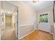 Bright hallway features hardwood floors, neutral walls, white trim, and a glass-paneled door for natural light at 659 Pleasant Hill Nw Rd, Conyers, GA 30012