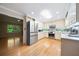 Well-lit kitchen features stainless steel appliances, light wood cabinets, and hardwood floors, creating a warm and inviting space at 659 Pleasant Hill Nw Rd, Conyers, GA 30012