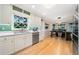 Bright kitchen with stainless steel appliances, light wood cabinets, hardwood floors, and a charming view of the backyard at 659 Pleasant Hill Nw Rd, Conyers, GA 30012